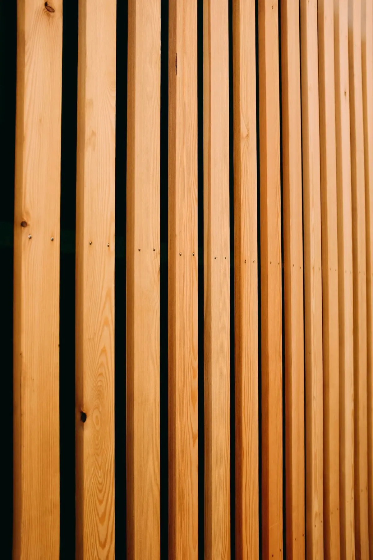 Detail of vertical wood slats with dark shadow gaps